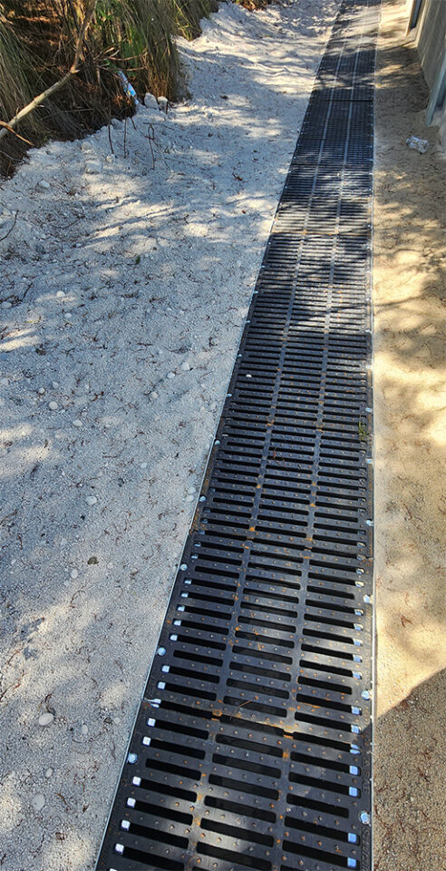 Large cast iron drain installed surrounded by sand